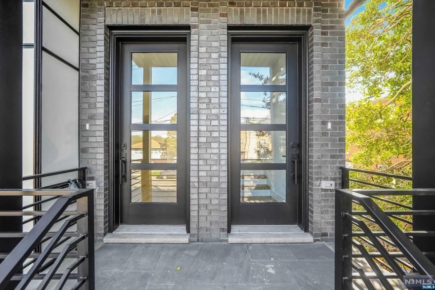 A modern new construction two-family home! The first and second floor unit of this home is a spacious 9-room living space with 2.5 baths. This home features sun-filled rooms and 9' ceilings throughout, creating an airy and open feel. As you enter your front door , you are welcomed into a spacious living room with plenty of natural light. The open floor plan leads into the kitchen, which is outfitted with modern appliances and ample counter space for meal preparation. The kitchen also has a sliding glass door that provides access to a private deck, perfect for outdoor dining or relaxation. Each unit has three generously sized bedrooms, each with large windows that let in plenty of sunlight. The master bedroom has an en-suite bathroom, complete with a modern glass-enclosed shower. The other two bedrooms share a full bathroom that features a tub and shower combo. The main unit also has an additional 3 room -1/2 bath, finished ground level with side entrance and sliding glass door.