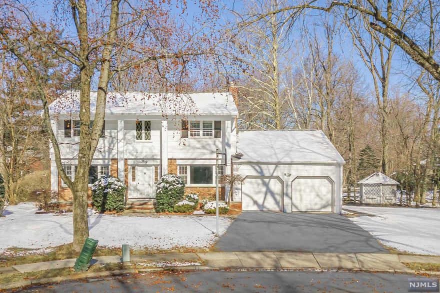 This is the Paramus home you've been waiting for! Delight in this beautiful 4 bed, 2.5 bath Colonial set at the end of a cup-de-sac on almost 1/2 an acre. The eat in kitchen with granite counters and SS appliances boasts lots of natural light overlooking the park like property. Front to back living, formal dining room and family room with a fireplace. Primary bedroom with full bath, 3 more bedrooms and main bath w/laundry. The lower level has lots of space and is ready to be decorated! Wonderful workshop or crafting room as well! This home has a 2 car attached garage and an oversized lot. Convenient to major highways. Fabulous low Paramus taxes ($10,122!). A terrific house and neighborhood to call home.