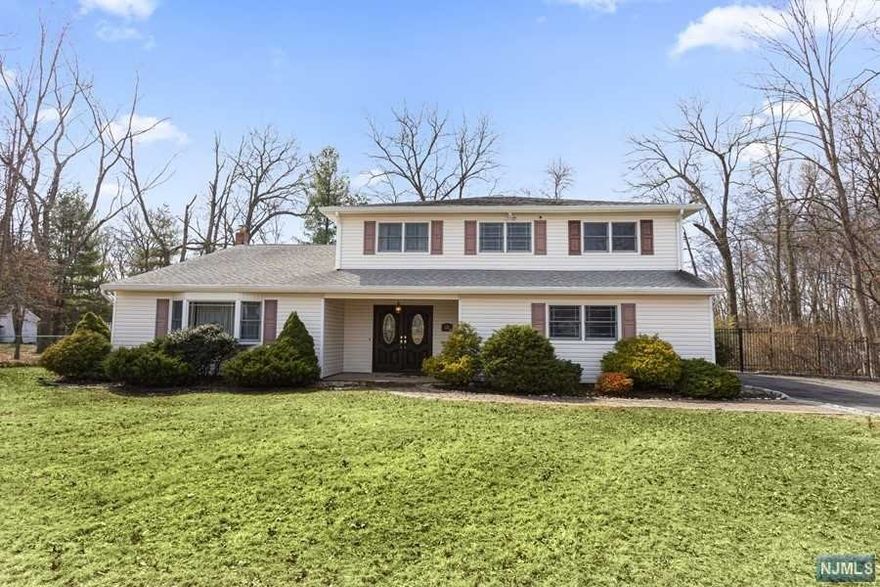 Large and airy home at the end of cul-de-sac located on a large fully fenced property. Big foyer with a coat closet continues to a cozy family room with bamboo floors and woodburning fireplace. On the same level there are an updated powder room, sunroom, laundry, and entrance to a 2-car garage. Several steps up, there is a living room, elevated dining room, and large custom kitchen with breakfast area. Top level has four spacious bedrooms, including the primary bedroom with its own dressing area and custom bath; hall bath is custom as well. Hardwood floors throughout (in primary bedroom, under the carpet). Nest thermostat is included. The property has a generator and a shed. House has multiple zone baseboard heat and central air.