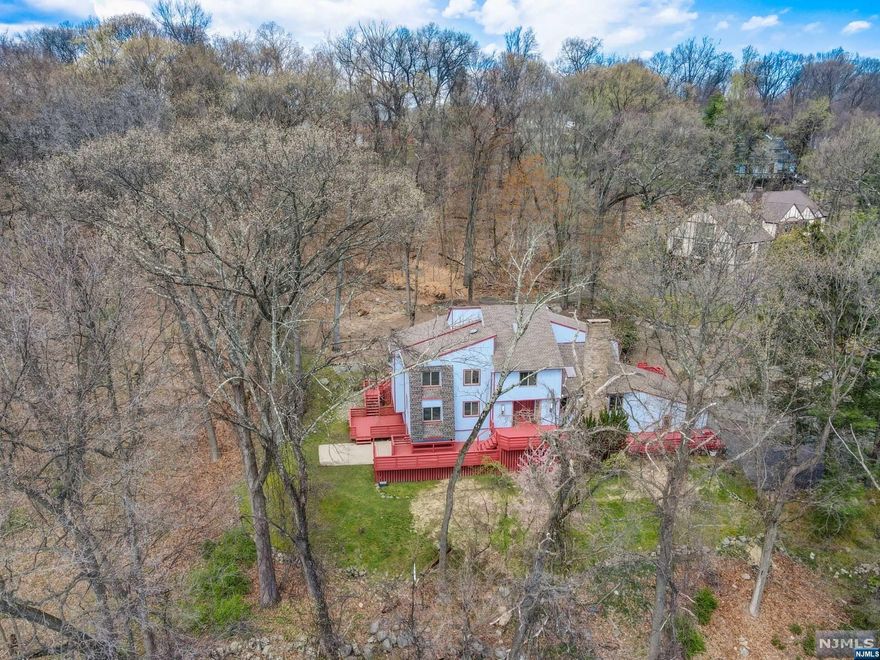 EXTREMELY COOL CONTEMPORARY WITH COLONIAL VIBES SITUATED ATOP A MOST PRIVATE CUL DE SAC ON 1.4 ACRES. EXPANSIVE FRONT & REAR DECK - IDEAL FOR ENTERTAINING. LARGE ENTRY FOYER OPENS TO FLR ON THE LEFT WITH VIEWS OF THE WOODS & TO SUNDRENCHED GREAT RM W VAULTED CEILINGS & FPL TO THE RIGHT. FRONT TO BACK GRT RM OPENS TO UPDATED KITCHEN, ACCESS TO REAR DECK & PRIVATE YARD, FORMAL DINING RM, LAUNDRY & PR. SECOND FL OFFERS 3 LARGE BEDROOMS, FBA, & MASTER ENSUITE. THIRD FL OFFERS BONUS ROOM & FBA. FINISHED LOWER LEVEL W SLIDERS TO SIDE PATIO FEATURES BAR, REC RM, FBA & ACCESS TO 2 CAR GARAGE. TREMENDOUS NATURAL LIGHT THRU-OUT. CONVENIENTLY LOCATED YET EXTREMELY PRIVATE SETTING. OVER 4,000 SQ FT OF LIVING SPACE. TREMENDOUS OPPORTUNITY. HARDWOOD UNDER CARPET ON 2ND FL.