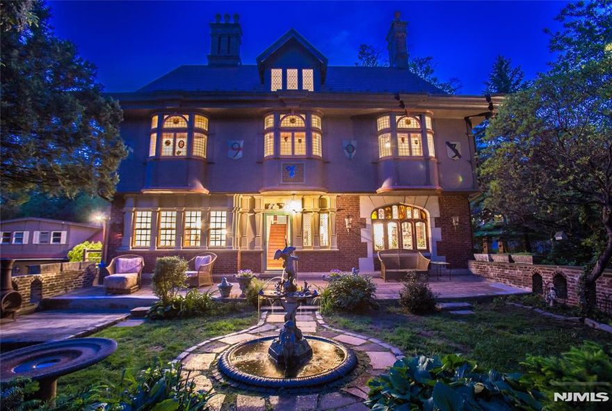 Travel back in time upon approaching this majestic estate & be wowed by every ornate detail including iron cast radiators attached to modern Priority heating system. Every inch of this manor will captivate including the stone gateways & stately fountain in entry terrace that opens to private & expansive grounds w/a palatial detached 7 car multi-level garage w/almost 1000 sq ft loft space--presenting w/such detail as an illuminated cupola & circular Tiffany-stained glass window towering over the garage. Adorn w/historic significance & mystic, this story book estate is prime for expansion or continued love w/endless possibilities.