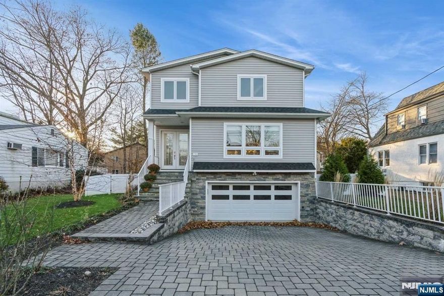 Beautiful & modern 2017-built colonial in Cresskill featuring 5 bedrooms, 3.5 bathrooms, and thoughtful design. This spacious home offers an open floor plan, plenty of natural light, and hardwood floors throughout. The modern kitchen with a center island and stainless-steel appliances opens to the dining and living rooms, complete w/ a cozy fireplace and a convenient powder room. The second floor includes a primary bedroom with an en-suite bathroom, three additional bedrooms, and a full bath. The finished basement adds extra living space with a recreation room, bedroom, and full bathroom. Additional features include recessed LED lighting, a paver driveway with an automatic snow and ice melting system, built-in closet systems, and insulation between floors. The flat, fenced property is beautifully landscaped with a patio. Includes a generator, sprinkler and alarm systems, central vac, and 3-zone AC/heat with humidifier and thermostats. Close to top-rated schools, NYC transportation