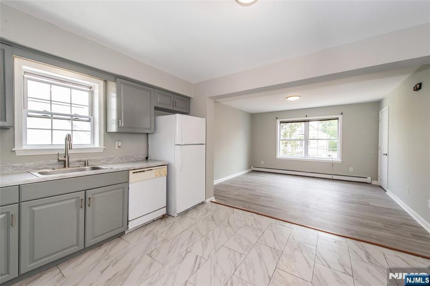 This bright and freshly updated 2nd-floor apartment features a spacious open-concept layout with large windows and stylish flooring throughout. The living room flows into a modern eat-in kitchen equipped with gray shaker cabinets, tile floors, and ample counter space. Enjoy two sun-filled bedrooms with generous closets, and a full bath with contemporary finishes. Additional highlights include neutral paint tones, great natural light, and baseboard heating. Conveniently located near shops, restaurants, and transportation.