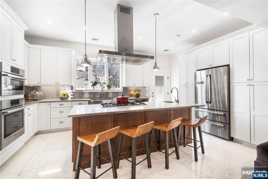This is a true Unicorn Property! An exceptional two-family residence (currently used as a one family) in one of North Bergenâ€™s most coveted pockets, just one block from North Hudson Park and moments off Boulevard East. The ownerâ€™s triplex unit has been meticulously designed for both elevated living and effortless entertaining. The main level features approximately 1,200 square feet of open-concept living and dining space anchored by a chef-caliber kitchen, with direct access to an expansive backyardâ€”ideal for indoor-outdoor flow. This level also includes a full bath and a separate mudroom entrance, offering practical day-to-day functionality. The second floor is thoughtfully laid out with three bedrooms and two full baths, including a junior suite with its own ensuite. A wet bar services a stunning ~600-square-foot private rear deck, delivering sweeping, unobstructed views of the Manhattan skylineâ€”an entertainerâ€™s dream. The top floor is dedicated entirely to a luxurious primary suite spanning over 800 square feet. This retreat offers a generous sitting area, three custom walk-in closets, and a spa-quality bath. A private terrace completes the space, again capturing direct, panoramic NYC views. The ground-level second unitâ€”configured as a two-bedroom, two-bath with its own private entrance. he property also offers the rare convenience of four-car parking and encompasses approximately 5,000 square feet of total living space. Seller is a licensed real estate broker.