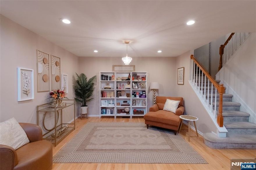 Welcome to Stonebridge at Wayne! Bright and spacious 3-bedroom, 2.5-bath townhome . Natural sunlight pours through the wall of windows and cathedral ceiling, filling the open-concept living and dining areas. The elegant kitchen features updated cabinetry, stainless steel appliances, African Rainbow marble countertops, breakfast island, and sliders to a private deck. A cozy family room with gas fireplace and powder room complete the first floor. Upstairs, the primary suite offers a walk-in closet and spa-like bath with jetted tub, stall shower, and dual vanities. The second bedroom is oversized and can be divided if desired; an additional bedroom, full bath, and laundry complete the level. The finished walk-out basement adds versatile living space, full-size windows, and ample storage. Enjoy community amenities including pool, tennis courts, and clubhouseâ€”all within a top-rated Wayne school district and convenient NYC commute.