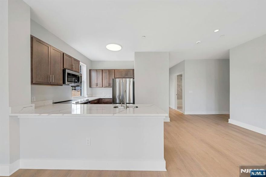 Discover refined urban living in this spacious 2 bedroom, 2 bath unit offering 1,253 sq. ft. of thoughtfully designed interior space. Located on the third floor of a newly built 18-unit elevator building, this corner home gets a ton of natural light. The open layout features a kitchen with LG stainless steel appliances, an electric range, and a dishwasher. The primary bedroom includes a walk-in closet and private en-suite bath, while the second bedroom offers flexibility for guest bedroom, guests, or additional lounging. A second full bath, dual zone heating and cooling, and oversized windows add to the comfort and livability. Residents enjoy access to a stylish lounge, basement laundry, and secure bike/scooter storage. Covered garage parking is available for $150/month. Net effective pricing with (one month free on a 24-month lease). Ready for immediate occupancy.