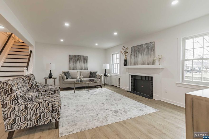 Welcome to this beautifully renovated home in the top-rated town of Fair Lawn! Upon being greeted with a freshly done, classic black and white exterior, enter to find an entry space with a coat closet, leading to a very spacious living room with a wood-burning fireplace. An open concept layout provides incredible sightlines to a formal living room and remodeled kitchen with all new appliances, breakfast bar and quartz countertops. Upstairs features huge primary bedroom with three closets and a new ensuite bath. Potential for a private, second floor terrace is ready to be completed by the home's new owners. The second story also features two additional bedrooms and a second full bath. The basement has a built-in bar, laundry, workshop/storage. Added amenities include new, durable luxury vinyl flooring throughout, recessed lighting, spacious yard and designer fixtures. Fair Lawn has top rated public schools, access to a town sand-bottom pool and easy NYC commute. NOT IN FLOOD ZONE!