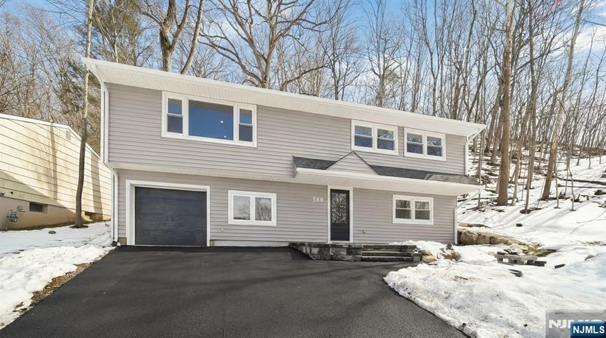 Welcome to 550 Ramapo Valley Road, a completely reimagined, ground up renovation bi-level style home ready for you to enjoy! This thoughtfully crafted home features new windows, roof, siding, flooring as well as all new mechanicals, plumbing, and electrical throughout, offering peace of mind with timeless style! Ground-level entry welcomes you into a spacious family room perfect for relaxing or entertaining, along with a private office, laundry area, full bath, and mudroom nook with direct access to the attached one-car garage. Newly installed french drains! Upstairs, the sun-filled open-concept main living area offers an airy, light-filled layout with mountain and lake views, and a cozy electric fireplace. The living room flows seamlessly into the dining area and stunning gourmet kitchen, featuring a center island, custom cabinetry with spectacular pantry closet, quartz countertops, and stainless steel appliances! Ideal for everyday living and hosting guests. The tranquil primary suite boasts 10 foot vaulted ceiling, three closets and a beautifully appointed full bath w/double vanity and shower. Two additional bedrooms and afull bath complete main level. Nothing to do but unpack, this warm and inviting home combines new modern craftsmanship with comfort and style. Oakland is known for excellent schools and rec programs, convenient commuting options, beautiful parks and recreation, shopping and restaurants! Home Sweet Home!