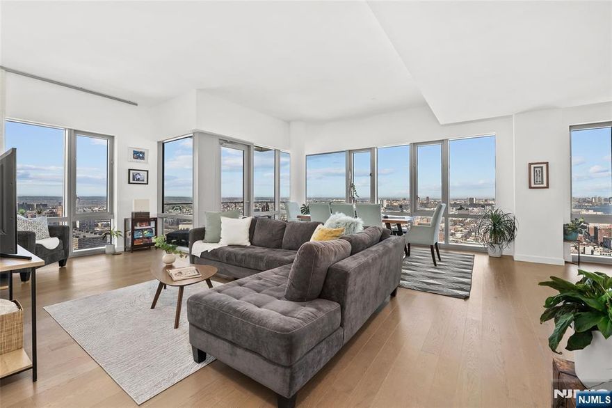 A rare penthouse resale at 75 Park Lane South. Residence PH 3701 is a stunning 2-bedroom, 2.5-bath corner penthouse spanning 1,481 sq ft with an 80 sq ft private terrace. Wrap-around floor-to-ceiling windows and high ceilings frame breathtaking panoramic views of the Hudson River, the Manhattan skyline, Hudson Yards, the George Washington Bridge, and the Jersey City skyline, with spectacular sunsets. The expansive living and dining area is ideal for entertaining and features a chefâ€™s kitchen with Madreperola Quartzite countertops, a waterfall island, premium Bosch appliances, and a rare exterior-vented hood. The primary suite offers sweeping city views, a walk-in closet, and a spa-inspired bath with Stellar White marble, frameless glass shower, soaking tub, and custom vanity. The second bedroom includes an ensuite bath. The home offers generous closet space and a private storage locker. Residents enjoy full-service luxury living with a 24-hour doorman, indoor lap pool, fitness center, spa with steam and sauna, wine lounge, private dining room, co-working and conference spaces, multimedia lounge, golf simulator, putting green, and landscaped rooftop sky lounge. Ideally located near the PATH Train, Light Rail, ferry, parks, shopping, and dining for easy access to Manhattan.