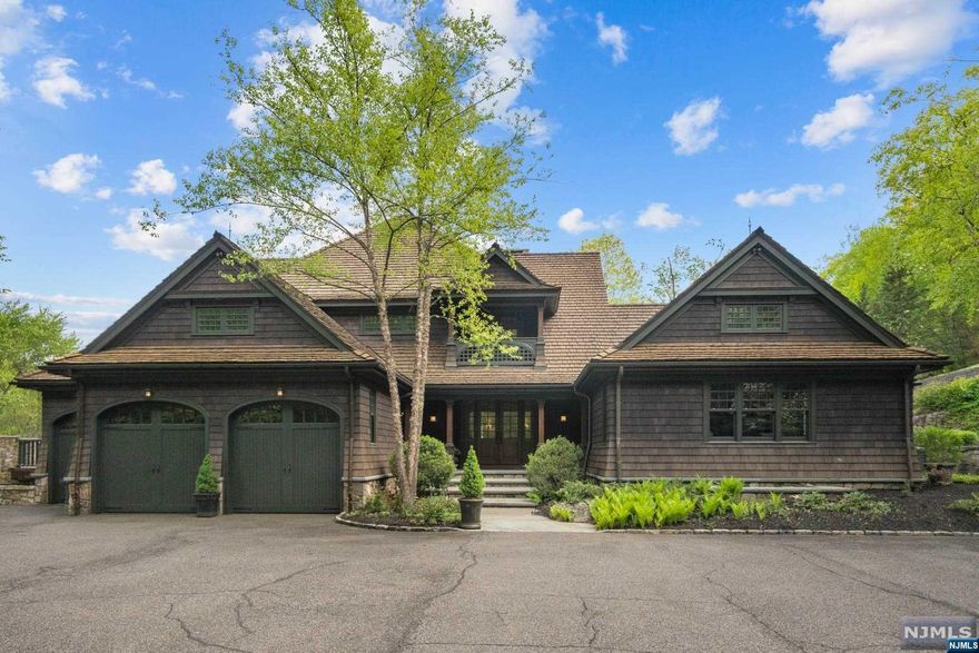 Escape to a private oasis on over 6 acres of lush woodlands in this stunning, one-of-a-kind custom home built by one of New Jersey's top builders, Polo Master Builders. Roughly 9,970 SqFt, this luxurious mansion is custom-designed by renowned master carpenter Jack Wright. The property boasts the finest amenities, including a heated in-ground pool w/ soothing waterfall, jacuzzi, lodge-style bar, theater, gym & sauna. The sun-drenched main level highlights detail-work like quarter-sawn Oak floors, a herringbone fireplace, a Chef's kitchen w/ a breakfast nook & pantry, soaring family room w/ stone fireplace, a gorgeous master suite w/ a tranquil porch, & a rich Oak-clad Study. This resort-like home is perfect for those who enjoy entertaining, relaxing, & indulging in luxurious amenities. The heated pool & jacuzzi provide a serene & refreshing environment to unwind, while the game room & theater are perfect for hosting guests. Minutes to Morristown, public transportation, & schools.