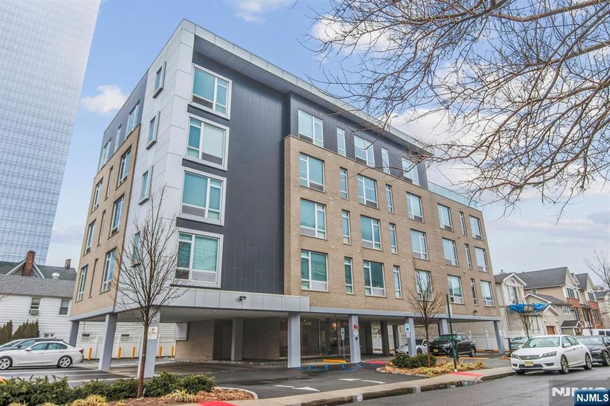 Welcome to The Cosmopolitan â€“ a boutique-style rental building just a short walk from everything Fort Lee has to offer! Enjoy easy access to Hudson Lights, the iPic Theater, great restaurants, shops, parks, and NYC transportationâ€”including a quick walk to the George Washington Bridge. The building features a stylish lobby, secure entry with access panel, and cameras throughout for peace of mind. Inside the apartment, you'll find 9-foot ceilings and an open layout that brings together the kitchen, living, and dining areas. The custom kitchen features crisp white 42" cabinets, black granite countertops, GE appliances, gas cooking, and a vented microwave. The spacious primary bedroom has a walk-in closet and private bath. Thereâ€™s also a roomy second bedroom with its own full bath and walk-in closetâ€”perfect for guests, family, or a home office. Large 8-foot windows let in tons of natural light and create a bright, modern feel. One assigned parking spot is included.