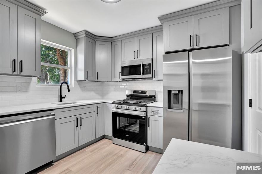 Welcome to this beautifully updated move in ready townhome without HOA fee's in East Orange. This spacious 3-bedroom, 1.5-bath home has been tastefully renovated with modern finishes throughout. Step inside to find recessed lighting, brand new luxury vinyl flooring, and freshly painted interiors that create a bright and inviting atmosphere. The stylish new kitchen has quartz countertops, a tiled backsplash, new cabinets and stainless steel appliances. Its perfect for cooking and entertaining. Both bathrooms have been fully remodeled with contemporary touches, while new doors and updated lighting enhance the home's modern feel. Enjoy the convenience of off-street parking with your own designated spot, plus a backyard that offers the perfect outdoor space for relaxing or entertaining. With nothing left to do but unpack, this home is ready for its next owner to enjoy.