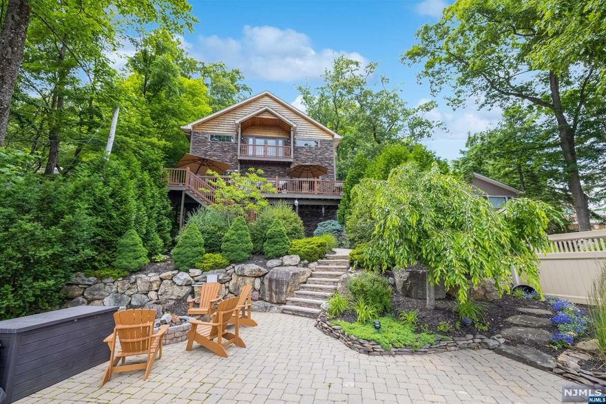 Welcome to a haven of sophistication and tranquility, where the serene beauty of Lake Hopatcong meets exquisite design and modern comforts. With a prime North Shore waterfront location, 44 Mason boasts breathtaking panoramic views, 3 bedrooms, 3 full bathrooms and a spacious entertaining oasis. Soaring ceilings from the main living room, a spacious kitchen with stainless steel appliances, custom cabinetry, and a large island perfect for casual dining and entertaining. The primary suite is a private retreat, complete with a spa-like ensuite bathroom, walk-in closet, and a private balcony over looking the water. Private dock with boat lift, expansive patio, and deck, create an outdoor paradise for dining, entertaining, and enjoying the lake's natural beauty. The home is being offered fully furnished and boat and 3 jet skis also available for sale.