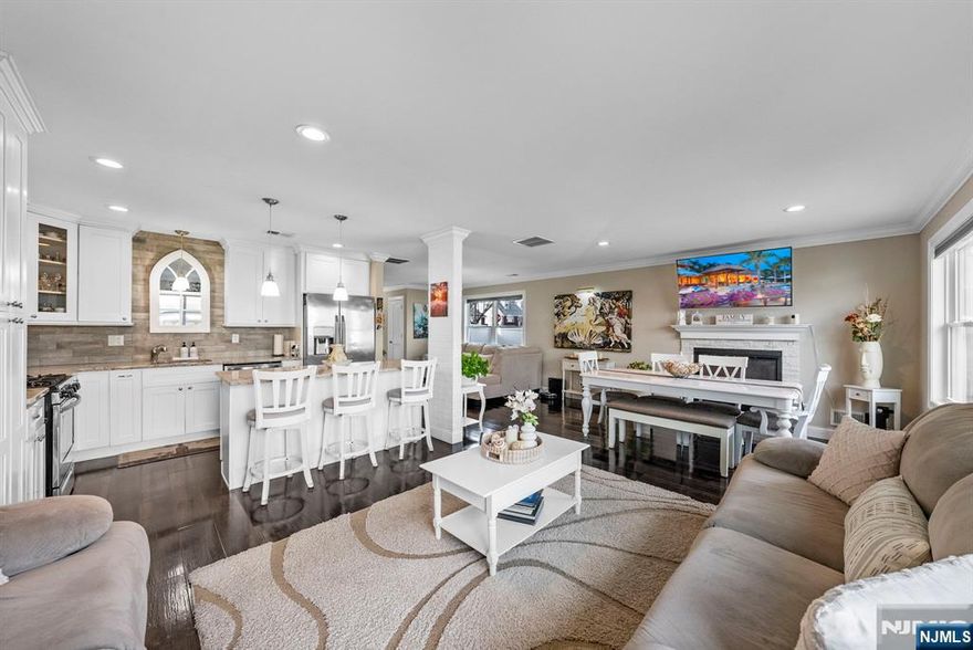 Welcome to this exceptional four-bedroom, 2.5-bath home offering elegant, modern living across three expansive levels. The first floor features a beautifully designed layout ideal for daily living and entertaining, with a gourmet kitchen flowing into the dining area and inviting living room anchored by a gas fireplace. Sliding doors lead to a large, fully fenced backyard with a private jacuzziâ€”perfect for relaxing or hosting. A convenient half bath completes this level. The second floor offers four generously sized bedrooms, including a serene primary suite with en-suite bath, an additional full bathroom, and a dedicated laundry room for added convenience. The third floor presents a massive open-concept space ideal for a home office, gym, recreation room, media lounge, or guest retreatâ€”endless possibilities to fit your lifestyle. Additional highlights include a rare two-car indoor garage plus a private two-car driveway. Ideally located near NYC transportation, shopping, gyms, and everyday conveniences, this home delivers space, sophistication, and accessibilityâ€”a truly impressive place to call home.