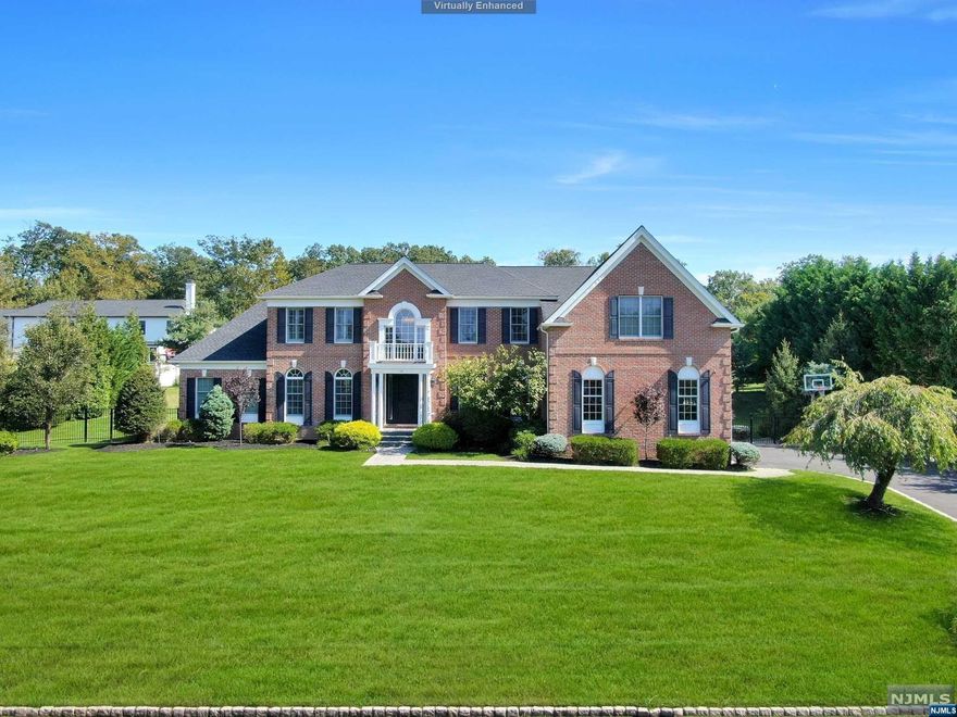 Nestled in the heart of Woodcliff Lake's Mulholland Estates, this Pristine Center Hall Manor Home is a true masterpiece of upscale design. The 2-story Grand entry foyer sets the tone, opening to an extraordinary Library/5th Bedroom & an inviting Living Room. The Cathedral ceiling Solarium offers magnificent space. The Center Island Kitchen could easily grace the pages of a design magazine, blending quartz, stainless steel & floating white cabinetry, opening to the 2 Story Great Room w/Fireplace. The incredible Primary Suite features a beautiful Sitting Rm, large Walk-in Closet & Primary Bath w/high-end design. Another Bedroom is En-Suite w/Full Bath, & two Additional Bedrooms have a Jack & Jill Bath. An expansive finished lower level w/High Ceilings features a media room, rec room, office, exercise room & bath. A 3 Car Garage, & Brick & Hardy Plank Siding complete this Remarkable home, located close to its top rated schools & NYC transportation! Absolutely Stunning!