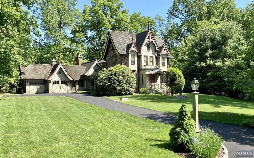 An extraordinary opportunity to reside on Tenafly's coveted East Hill in a stunning one-of-a-kind home. A piece of history, this stone Gothic Revival masterpiece (featured in numerous publications) underwent major renovations in 2010, including a newly-constructed great room with 15 ft vaulted ceilings & exposed wood beams, Rumsford fireplace, guest suite w/ separate entrance, finished basement w/ high ceilings & 2-car garage with custom carriage doors. Original charm with modern upgrades to the gourmet kitchen, bathrms, bedrms, windows & pressure-treated cedar shingle & copper roofs. Located on over 1.2 acres of manicured, park-like grounds w/ European soaking pool, blue stone patio, covered porch, charming gazebo, additional 2-car garage & newly paved driveway, this secluded property borders Davis Johnson Park with a high stone wall. The 3 level-home features 6 bedrms, 4.5 baths & hardwd floors throughout. Walking distance to Tenafly's Blue Ribbon schools & NYC transportation.