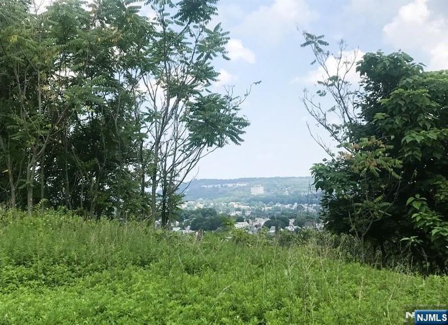 Exceptional 1.22-acre estate lot (53,143 SF) in Totowa's desirable Dey Hill sectionâ€”ideal for privacy and prestige. Zoned prime R-20 Single-Family Residential, this grand parcel far exceeds minimum requirements, nestled amid strong neighborhood values. Gently rolling, mature-wooded site boasts unmatched Columbus Ave frontage, commanding curb appeal, and vast space for pool, sport court, outdoor kitchen, or gated entryâ€”all compliant with generous Borough setbacks. Public utilities available at street (buyer to verify connection). Trophy opportunity for visionary owner-builders: the last oversized homesite in this established, high-demand enclave where custom estates command top dollar. Secure your legacy address before it's GONE.