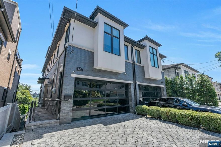 Meticulously crafted 5,000 square foot townhome by Rock Solid Builders. Spanning four levels, this home boasts 4 bedrooms, each complemented by its own lavish ensuite. The living room, adorned with a bespoke stone fireplace, features soaring 10-foot ceilings and floor-to-ceiling windows offering views of the Hudson River. Gourmet kitchen w/ complete with professional-grade appliances, perfect for culinary enthusiasts. Ascend to the master suite, where a cozy fireplace awaits alongside spa bathroom and built-in closet. The pinnacle of sophistication awaits on the top floor, where a family room and half bath lead to an expansive roof deck, commanding breathtaking panoramas of New York City to the George Washington Bridge. The ground level boasts vaulted ceilings, bedroom, full bath, and direct backyard access, seamlessly blending indoor and outdoor living. Smart home is equipped with modern amenities such as a Crestron system, automated blinds, two-car garage, elevator.