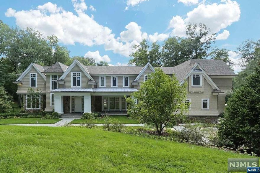Nestled behind gates, this magnificent stone & cedar shake home embodies Greenwich-style luxury, boasting over 10,000 square feet of pure opulence. The open floor plan features a two-story great room with stunning views of the meticulously manicured 1.9-acre property. Throughout the home, you'll find extensive molding & trim work. Each bedroom is an en suite, with the master suite offering a sitting room, designer bath, custom closets, & a private balcony that will take your breath away. This home is equipped with high-end features, including an elevator, home theater with Crestron system, cherry-paneled office, & a gourmet kitchen outfitted with Wolf stoves & double Sub-Zero refrigerators. Additional amenities include a full bar, cabana, & a walkout lower level. Built by Rock Ridge Construction, the home showcases the highest level of craftsmanship & includes a covered patio. Such a home is a rare find, offering unparalleled luxury & sophistication. Taxes can be appealed.