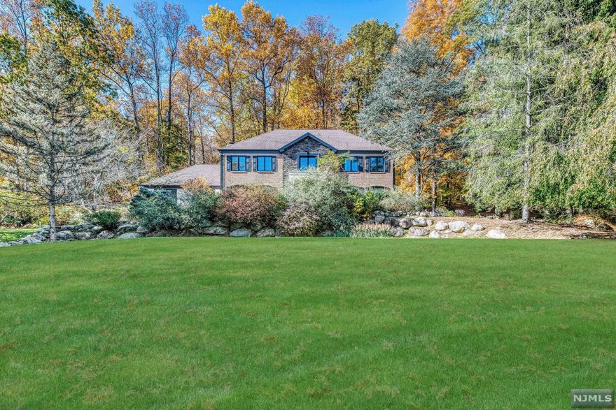 Stunning decorator showplace! Nested on private property at cul-de-sac. Ready to move right in, this beautifully updated 4 bedroom colonial includes elegant woodworking throughout, pristine hardwood flooring and beautiful lighting. The vaulted ceiling great room with dual wall fireplace is a comfortable place to entertain. A custom kitchen with top of the line appliances. Grand sized rooms, beautiful master bathroom, A/C and more...