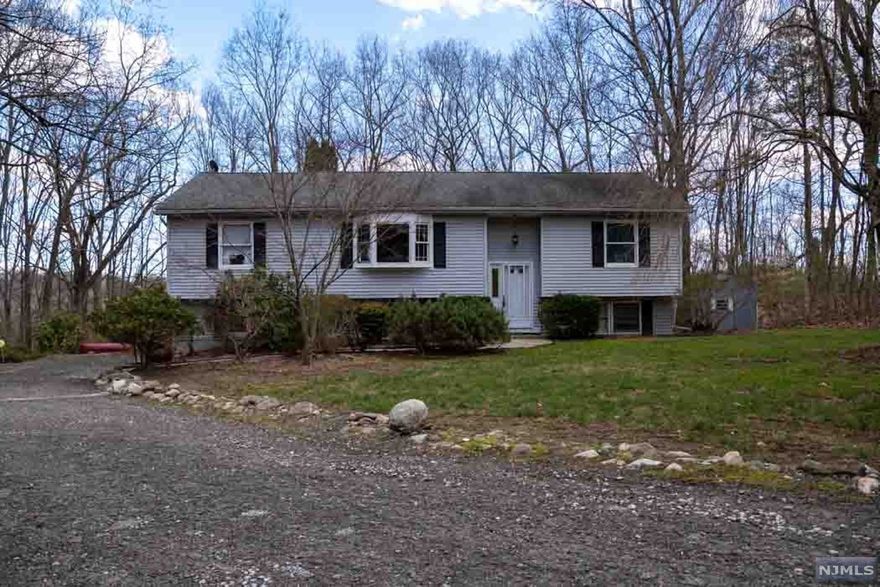 Beautifully kept and updated home in private setting. Garage was converted to 2 large rooms ( easy to undo). Main floor with split bdrm setup. HUGE open LR,DR,KIT w/ hardwd floor. Newer kit w/ SS, granite, and large center island. Large primary bdrm w/ full bath. 2 other bdrms w/ shared bath.