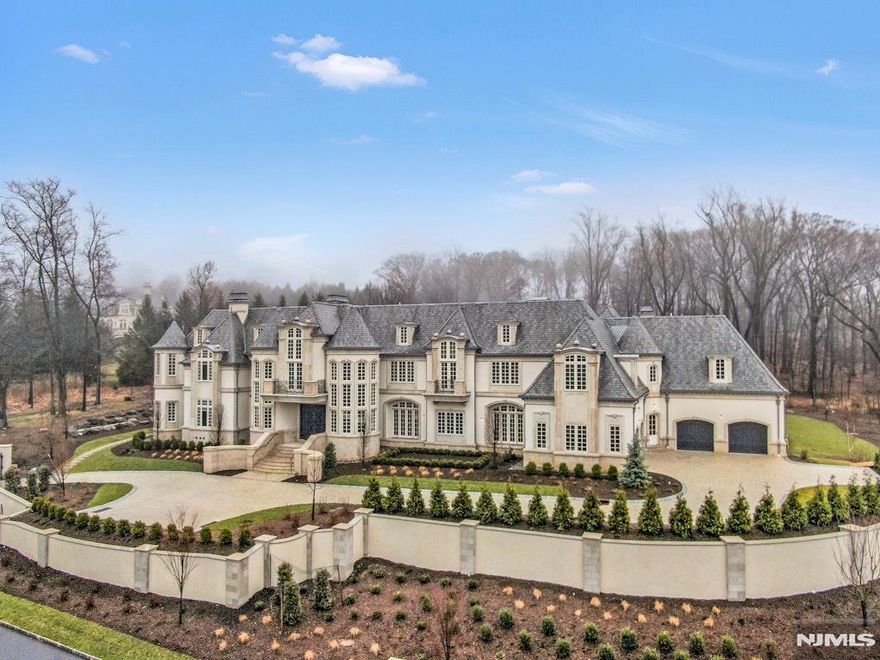 A newly completed interior renovation has transformed 10 Frick Dr into an architectural estate of extraordinary grandeur.. Spanning 24,000 sq ft across 4 thoughtfully designed levels, this 9 BR , 11 full and 3 half bathroom residence offers a rare combination of scale and functionality on a 2 ac lot, situated on the only private guard-gated street in all of Alpine. Beyond its architectural presence, the home unfolds as a fully realized lifestyle compound. The entry is framed by double doors opening into the great room w/ fpl and triple French doors. The kitchen is an architectural statement featuring a deeply coffered ceiling and marble island w/waterfall edge. The adjacent family room is wrapped in custom millwork and at the heart of the home is a dramatic 18â€™ x 32â€™ indoor pool. A 300 SF+/- spa complements the space. Upstairs, the primary suite is a vaulted retreat with a limestone fireplace and wall upholstery in Phillip Jeffries linen. The lower level is dedicated to entertainment and wellness, featuring a glass enclosed wine room, immersive theater, spa lounge with cold plunge, sauna, steam room, massage area, and fitness suite. A heated garage with ceiling heights suitable for lifts offers the potential for expanded capacity. Outdoor living is equally articulated. At the rear of the home, a dining terrace adjoins a colonnade of stone arches. The outdoor kitchen is fully equipped with a refrigerator, BBQ, sink, and ice maker, and opens to expansive lawns.