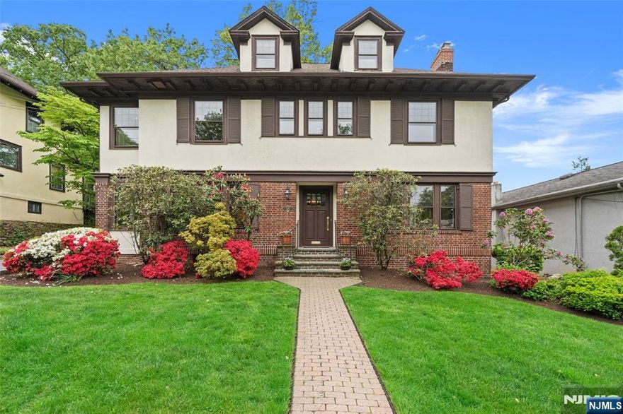 Welcome to this stately, brick center hall colonial nestled in the desirable Nutley Park sectionâ€”just a short stroll from scenic parks and convenient public transportation to NYC. This home is the perfect blend of classic charm and modern updates. Step inside the large foyer and discover the beauty of this home with several original hardwood details, including a gracious stairway! A traditional layout offers a perfectly sized living room with fireplace, formal dining room, cozy bonus room and a newly renovated eat-in kitchen! A convenient ground level powder room and laundry room are accessible through the kitchen or back door . Upstairs, youâ€™ll find numerous generously sized bedrooms providing plenty of space. The walk-up attic is currently unfinished but brimming with potential for an additional bedroom, office or private retreat. The fully finished basement has a retro-style bar, bathroom, and plenty of room for recreation or gatherings. Outside, the oversized detached garage is perfect for storage, hobbies, or additional parking. With its unbeatable location, spacious layout, and perfect mix of old-world charm with modern amenities, this is a rare opportunity to own a truly special home in Nutley Park. Donâ€™t miss it!