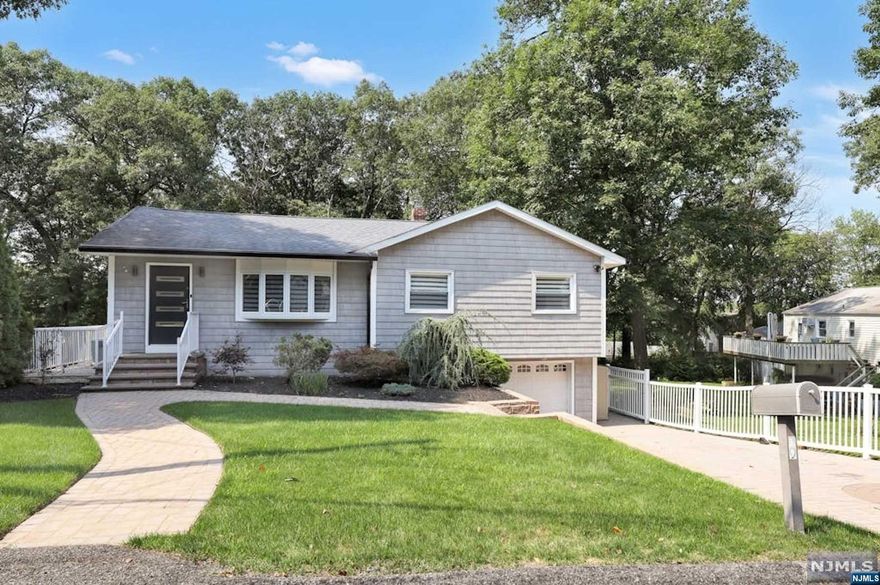 Discover your dream home in Ringwood's desirable Skyline Lakes neighborhood! This stunning ranch-style residence blends modern European elegance w/ comfort. Featuring a stylish paver-block driveway, 1-car garage, & high-end fixtures throughout. The open-concept living areas showcase a chef's kitchen w/ large island, gas cooktop, & premium amenities. Wood-burning stove & spacious deck ideal for entertaining. Main floor offers 3 generous bedrooms & a beautifully designed bathroom. Contemporary finishes and custom lighting. The finished basement is perfect for hosting w/ a chic bar, full bath & ample storage. Outside, a flat, fenced yard includes an above-ground pool, outdoor kitchen, & hot tub. Optional Skyline Lakes membership grants access to community events like swimming lessons, fishing contests, and more. Convenient for NYC commuters via NJ Transit or I-287, this home offers luxury, functionality, & a vibrant community lifestyle.