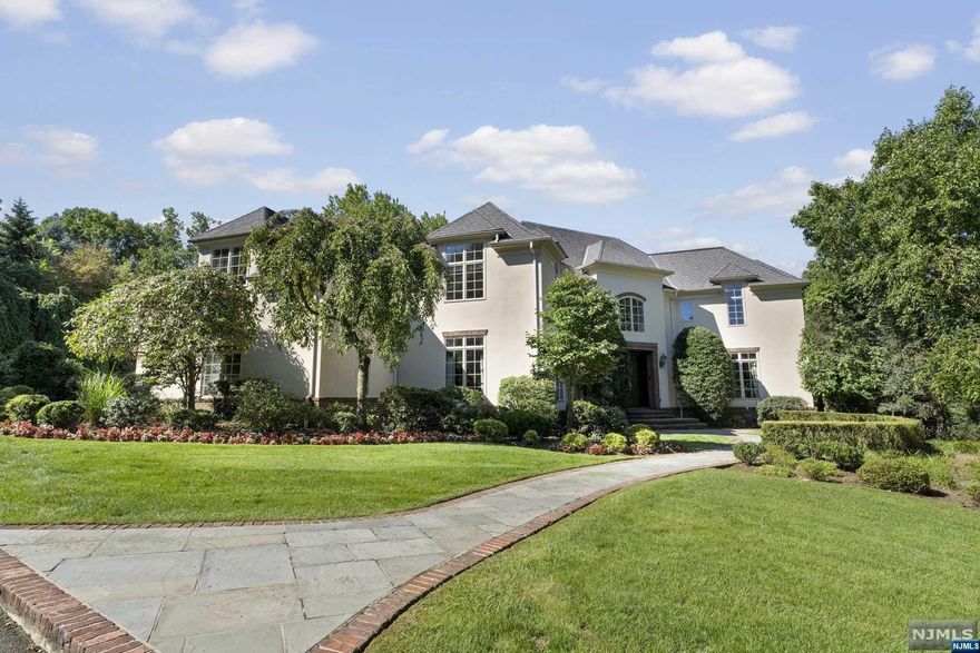 Move into this fabulous home with massive rooms, high ceilings, and herringbone floors. This must-see property, high on the East Hill overlooking the Ramapo mountains, is perfect for entertaining with a spacious living room and a library. The state-of-the-art kitchen has a sitting area with a fireplace and a banquet-sized dining room. On the second floor is the primary bedroom, which includes a fireplace, walk-in closets, and a contemporary bathroom. Additionally, this floor consists of four bedrooms and two bathrooms. The lower level has a guest area with ample space, two bedrooms, one and a half baths, a living room with a fireplace, a kitchen, and a gym. Don't miss the opportunity to live in one of Bergen County's most prestigious towns!