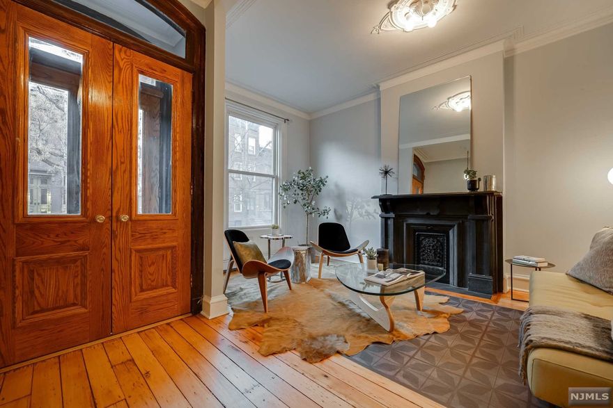 This beautiful uptown 3 bedroom/ 2.5 bath Victorian townhouse delivers the best in old world charm and updated with every modern convenience.The garden level features a large living space, powder room, and bright kitchen with exposed brick, gray granite island, imported Portuguese tile backsplash, stainless appliances, and a built in corner seat that overlooks the large perennial garden and brick patio. The parlor level has a beautiful sitting room with original mantel and high ceilings and a large bedroom and full bath with walk in shower. The upstairs bedrooms are spacious and bright with decorative tin ceilings and a full bath featuring a claw foot tub. This home includes CAC, custom built-in's, restored double doors, pumpkin pine floors, decorative mantles, and shutters. The added storage under the front stoop is great for storing stroller, bikes& shovels. Make yourself at home in one of Hoboken's great original homes on one of its best blocks.