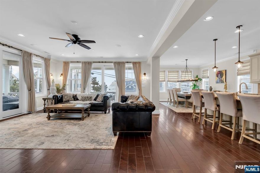 Make this summer your own at the beach--where coastal living meets privacy, space, and sweeping water views. Designed for effortless living, this exceptional beach block residence offers a rare blend of luxury and convenience, complete with private elevator access to every level. From the moment you enter, the home unfolds with a sense of versatility and comfort. The lower level creates a private retreat ideal for guests or extended living, featuring spacious accommodations, a full bath, and flexible areas that easily adapt to a lounge, office, or media space. Upstairs, the home transitions into its main living experience--bright, open, and designed for connection. The kitchen, living, and dining areas flow seamlessly, filled with natural light and opening to a wraparound balcony. for both entertaining and quiet moments overlooking the water. At the top level, the home becomes a true retreat. The primary suite offers a sense of separation and calm, complete with its own private outdoor space, while an additional ensuite bedroom ensures comfort and privacy for guests. With wraparound balconies on every level and a layout that balances openness with privacy, this home delivers a refined coastal lifestyle just moments from everything Long Branch has to offer.