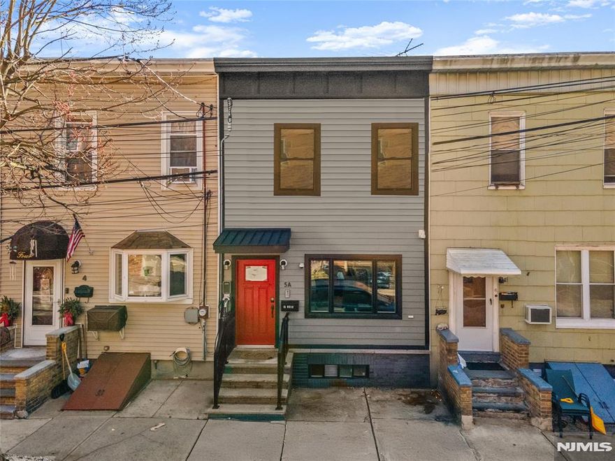 Charming three finished floor row home located in the vibrant and historic Shades of Weehawken, just moments from NYC and only a short stroll into Hoboken. This location offers one of the most convenient commutes to Manhattan while still enjoying the character and charm of a neighborhood setting. The main level features an open layout where the kitchen and living area flow seamlessly together, creating a comfortable and functional space for everyday living and entertaining. An oversized window fills the room with natural light, while a convenient powder room completes the first floor. From here, step directly outside to your own private backyard featuring a deck and paver patio below â€” a rare and valuable outdoor retreat so close to the city. Upstairs, you will find two bedrooms with comfortable ceiling height along with a full bathroom. The finished basement adds even more versatility with a large bonus area perfect for a media room, home office, gym, or play space, along with a dedicated laundry area. Conveniently located minutes from buses, NYC Port Authority Ferry, and Lincoln Harbor Light Rail, with quick access to the Hudson River waterfront, bike paths, dining, entertainment, and shopping. This home offers a great opportunity to enjoy city adjacent living with the added benefit of private outdoor space.