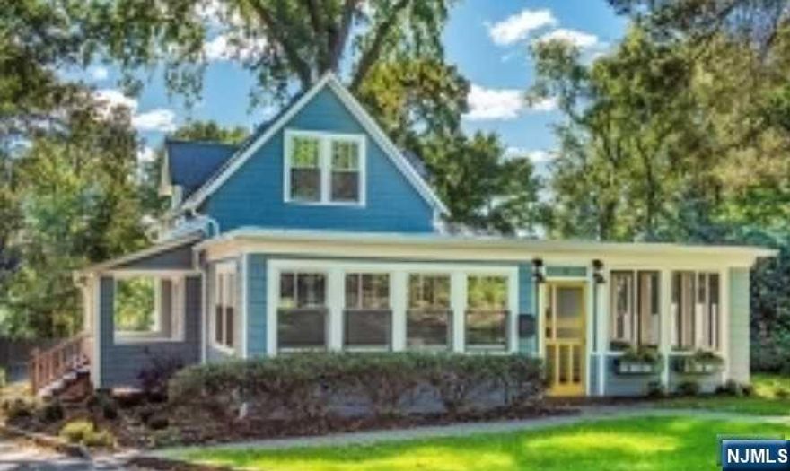 This stunning 3 bedrooms and 2.5 bathrooms craftsman style cottage is located within the prestigious gated community of Llewelyn Park. The home is designed to create a seamless connection with nature, with rich wood tones throughout and an abundance of oversized Pella windows that allow for plenty of natural light. Inside, you'll find gleaming hardwood floors, luxury lighting, and a main level primary suite with vaulted ceilings, cedar lined closet and en-suite bathroom featuring sophisticated RH finishes and a charming claw foot tub. Completing the main level are formal living and dining rooms, family room, powder room, expansive screened-in porch, and a gorgeous kitchen with center island, AGA range, and luxury line KitchenAid appliances. Sliders from the kitchen lead to a 590 sq ft Trex deck featuring a gas grill and firepit. The finished walkout basement offers a rec room, home office/guest space and custom cedar closets.