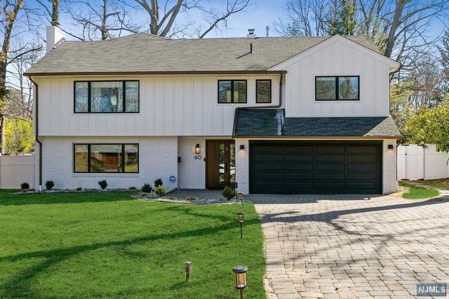 East Hill of Tenafly, beautiful light filled home fully newly renovated w/spacious open layout, located on one of Tenafly's most desirable streets. Entry foyer leads to a den/bedroom w/fireplace and built in closet, large living room, huge dining room and sunlit family room w/ wall of windows and sliding doors to a beautiful deck, overlooking a park-like private yard. Bright eat-in-kitchen has an island, skylights, sliding doors to deck, a walk-in pantry and powder room. Upstairs, two large bedrooms with double closets and two full bathrooms. A few steps up leads to private master bedroom floor w/ luxurious bath w/ skylight, jetted tub, steam shower, walk in closet and vaulted ceiling. The finished basement offers rec room, laundry and storage. Beautiful hardwood floors throughout, all new appliances, newer furnace and hot water heater. Garage equipped with a 240v, 60 amp system for electric car. Top location, near schools, house of worship, transportation and lovely downtown.