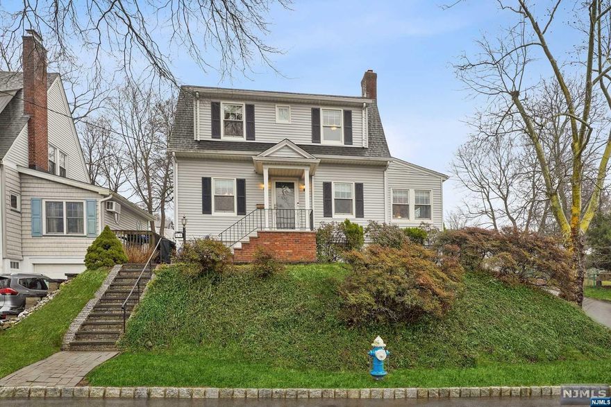 UPDATED center hall colonial exudes PRIDE OF OWNERSHIP in a prime location, just minutes from schools, parks, shops & restaurants, major highways, NYC transportation & free Jitney shuttle to multiple train stations. The EIK was RENOVATED in 2016 and boasts stainless steel appliances, tile backsplash & Corian counters. The living room has a wood-burning fireplace & built-ins. A formal dining rm & den complete this level. Upstairs, you'll find 3 bedrooms & a full bath w/heated floor & tub shower. The finished lower level has a spacious rec. room, powder room, laundry & storage. Fenced-in yard with 2 paver patios & open porch for outdoor living. Recent updates include NEW chimney liner, dishwasher, washer & dryer, freshly painted interior. Also includes cherry hardwood flooring, 3-zone boiler, portable generator hook up, Andersen windows, gutter guards, fireplace mantel, driveway resurfaced, whole-house attic fan, electric panel upgraded to 200amp, split A/C system & much more!