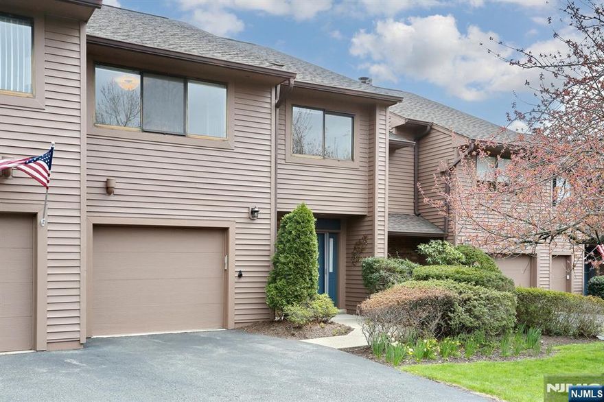 Welcome to Washington Commons, where comfort meets convenience! Step into this beautiful 3-bedroom, 2.5-bath townhouse offering a perfect blend of space, style, and natural light. The bright eat-in kitchen features granite countertops and sleek stainless-steel appliances, ideal for casual meals or morning coffee. The open-concept dining and living area, framed by a wall of windows and warm hardwood floors, creates a welcoming space for entertaining or relaxing. The oversized primary suite offers a peaceful retreat with a walk-in closet, private bath, and a bonus area, perfect for a home office or cozy sitting nook. Two additional spacious bedrooms and a full hall bath. The fully finished walk-out, lower level boasts a generous living area with stone fireplace, powder room, and sliding doors that open to a private, fenced patio for outdoor dining, relaxing, or gardening. Washington Commons offers wonderful community amenities, including a pool, tennis courts, playground, and clubhouse. All this, plus easy access to shopping, dining, and NYC transitâ€”this is townhouse living at its best!