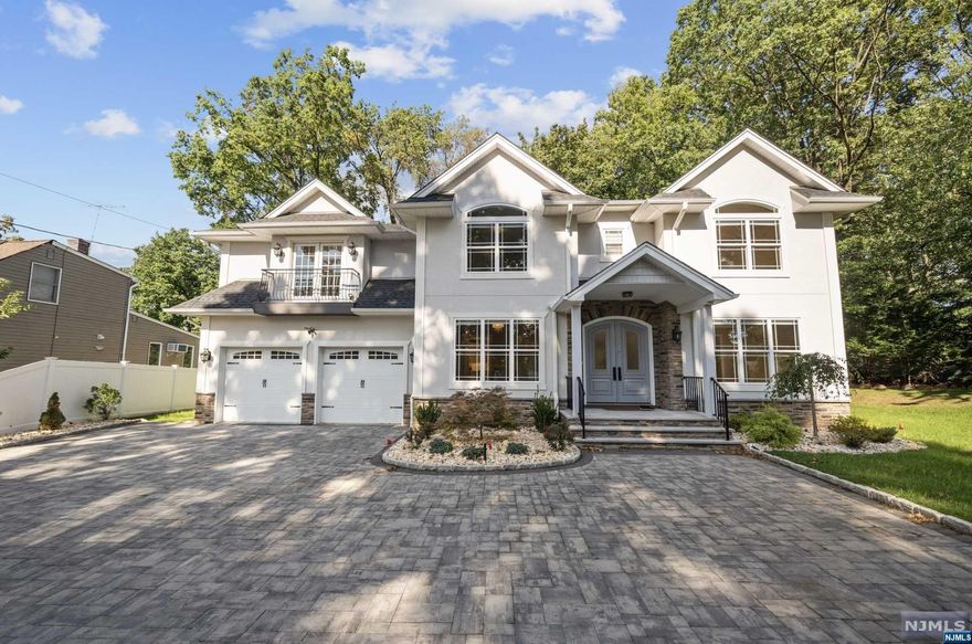 Stunning and oversized colonial on a quiet, dead-end street in Fair Lawn. This beautiful home features 4 bedrooms, 4.5 bathrooms, a fully finished basement, a 2 car garage, and an amazing backyard. Great floor plan with formal LR and DR flanking the welcoming entrance foyer. Gourmet kitchen with huge prep island. Luxury appliance package with microwave in island & beverage center. Open-Concept layout with family room with gas FP and breakfast nook off of the kitchen. Head upstairs to the huge Primary Suite that boasts massive primary bathroom with soaking tub and large glass shower. Junior Suite with private en-suite bathroom is an added bonus. Laundry on the top floor plus 2 additional bedrooms and a shared hallway bathroom complete the 2nd level. Finished basement hosts wet bar, large family room, and bonus office room. Backyard features huge paver patio and driveway in front of home is massive and can host multiple vehicles. You will absolutely love this home.