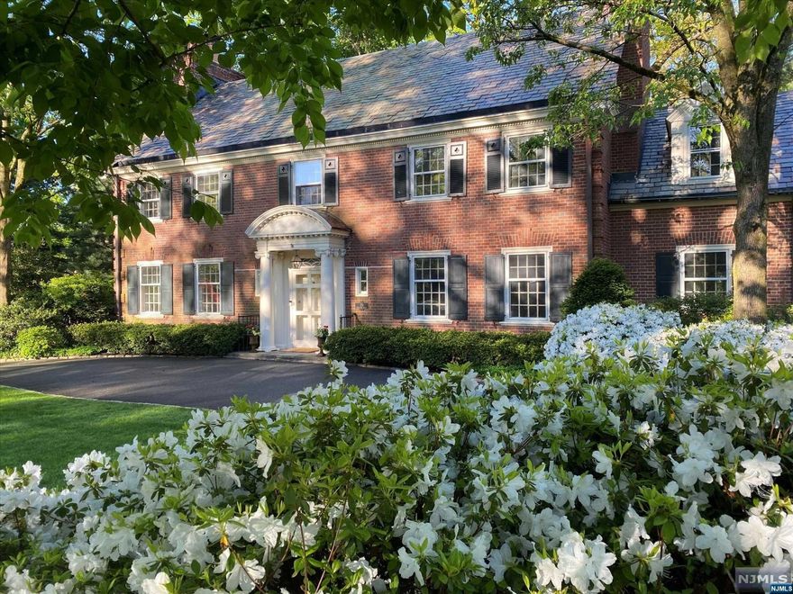 This Georgian-style home, designed by renowned architect John Russell Pope, is situated on a quiet street on 2/3 of an acre of beautiful landscaping and mature plantings. Step inside and you'll be in awe of the magnificent architectural detail and modern updates that have been carefully curated throughout. The new Chef's Kitchen is highlighted by a stunning 10' double mitered quartz island, custom inset cabinetry, an English farmhouse sink and includes a separate Breakfast area and combination Butlers Pantry/Wet Bar. The main floor also includes a beautiful LR with a wood-burning fireplace, an inviting formal DR with a gas fireplace, and a charming Sunroom w/ a curved exterior wall and a triple set of French doors opening to the fully fenced yard. Outside a bluestone patio, hand-crafted wood-burning fireplace, Walpole pergola, and hot tub are illuminated by moon lights. Upstairs is a primary suite with a newly renovated bath, 4 additional bedrooms and 3 additional baths.