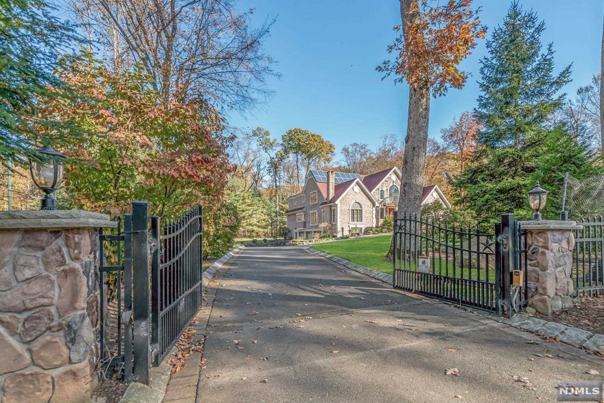 Elegant Saddle River Colonial, situated on a gated private lot and quiet cul-de-sac off Chestnut Ridge Rd. Redesigned and renovated in the past 10 yrs including a two story grand entrance & marble flooring. Luxurious radiant heat added and an elevator installed for convenience. Bright and impeccably maintained boasting hardwood flrs and open floor plan. Ease and function are the hallmarks of this home. White oversized Kitch is perfect for entertaining, flows into formal DR, office/Lib. and great FAM RM w/a soaring ceiling. Spacious 1st flr primary suite w/built-in closets & sitting rm. First flr laundry, pwdr rm, and 2nd en-suite BR. Grand staircase & landing lead to 2 more en-suite BRS and 2nd primary suite w/newly finished spa-bath & WIC.Custom closets and built-in storage throughout.New basement full finished including multiple rooms for a gym, tv/game rm/theater & custom cedar closet.Large windows make this valuable living space. Attached 3 car garage, security & so much more!