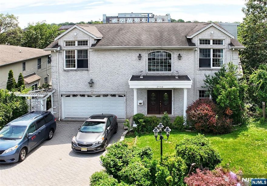 Welcome to this stunning and oversized center hall colonial located in the peaceful Fort Lee neighborhood less than 2 miles from the George Washington Bridge. With approximately 4,310sf of beautifully designed living space, this home offers timeless architectural charm blended with modern comfort - featuring soaring ceilings, exquisite trim work, and a unique, flowing layout rarely found in todayâ€™s homes. Step into the sun-drenched main level, where a gracious open floor plan effortlessly connects a chefâ€™s kitchenâ€”complete with a center island and breakfast areaâ€”to the inviting living room with fireplace, an oversized formal dining room, and a spacious family room, perfect for entertaining or everyday living. Upstairs, retreat to the primary suite, featuring a cozy fireplace, generous walk-in closet, and a spa-like en-suite bathroom with a jacuzzi tub and steam shower. The second floor also offers a private en-suite bedroom and two additional spacious bedrooms, both with ample closets and private balconies for added charm. Large windows throughout the home flood the interiors with natural light, highlighting the scale and flow of each room. The lower level is ideal for multi-generational living or guests, featuring a fully equipped guest suite with a living area, summer kitchen, bedroom, office space, full bath, and glass doors that open directly to the backyardâ€”perfect for a private retreat or extended stays. Owner has NJ real estate license.