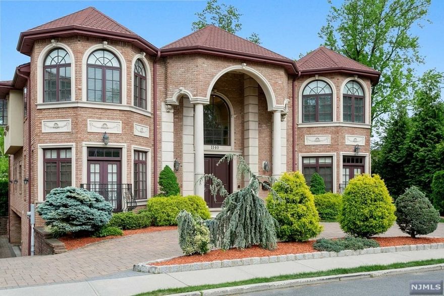 Located in a wonderful neighborhood, high on the Fort Lee bluff, sits this majestic home featuring first class amenities and approx. 10,000 sf of living space. This stunning brick colonial offers 6 bedrooms (all with walk-in closets), 5 full baths & 1 powder room. Custom tile and hardwood floors throughout. 4 zone A/C, 10 zone heat, 3 zone radiant with surround sound speakers throughout. 20' soaring ceiling in family room! Oversized gourmet kitchen is a chef's dream with hi-end appliances, custom cabinetry & Butler pantry with sink & wine bar. An expansive, finished lower level includes a sleek Home Theatre, marvelous Billiards Room w/Bar, Wine Closet, Sauna/Steam Room, bedroom with separate bath and a walkout to a professionally landscaped backyard. A 3-car garage, generator and lawn sprinkler system completes this well maintained home. Don't miss this opportunity to own in the Bluffs!