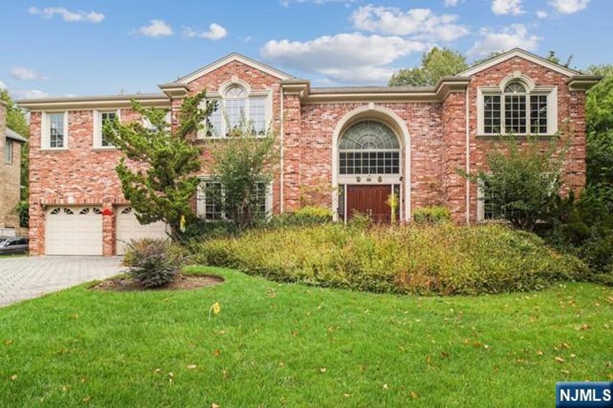 A custom built home nestled in the North Cliffs location in Englewood Cliffs (built in 1999) As soon as you walk in you are greeted with a grand entrance foyer and an expansive open floor plan.The first floor features two gourmet chefs kitchens with high end appliances which opens to the den/family room with a fireplace, library, Grand formal dining room, sunroom and 2 in-law suite. The 2nd Floor features a Master suite with sitting/reading room -large walk in closets, 2 Large Bedrooms share a full bath, other 3 large bedrooms share full bath. Custom details abound from the hardwood flooring to the beautiful moulding. The spacious backyard is fenced in with lush greens, beautifully landscaping and a patio. This home is is mintre away from NYC and all major highways, has a 3 car garage, solar energy & generator.