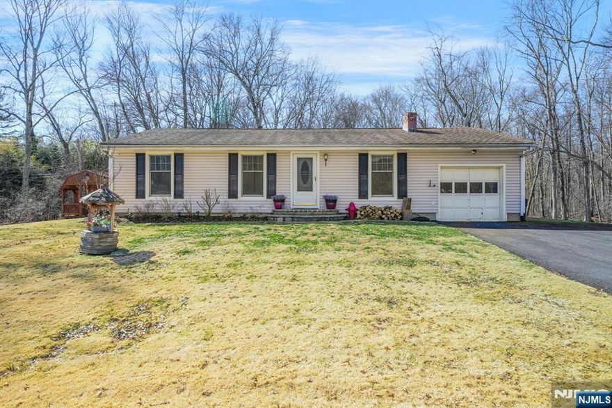 Welcome to an opportunity to put down roots in highly sought-after Montville Township. Situated on a quiet street, this three-bedroom, one-and-a-half-bath home rests on a flat, oversized lot offering strong potential for renovation, expansion, or personalization. The property's exterior already delivers standout features, including a large deck ideal for entertaining, a dedicated fire pit area, oversized storage shed, and a newly paved driveway with ample off-street parking. The generous yard provides flexibility for future outdoor enhancements while maintaining privacy and usable space. Inside, the home offers a functional layout with solid underlying structure, making it an ideal candidate for buyers looking to update and build equity over time. A wood-burning stove adds character and warmth, and the main bathroom features a whirlpool tub. A newer oil tank is conveniently located in the garage. Public water and gas connections are available in the street, providing additional long-term improvement potential. Whether you are an end user seeking to customize a home to your taste or an investor looking for a property with upside in a strong market, this is a rare chance to secure value in one of Morris County's most sought-after communities.