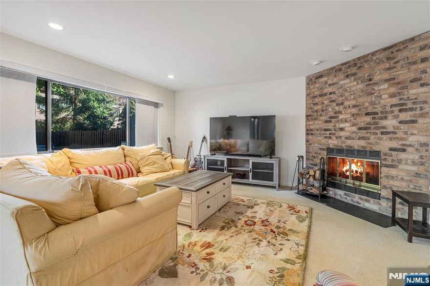 Welcome to Washington Commons! A Perfect Blend of Space, Comfort & Convenience This highly desirable end-unit townhouse offers the ideal combination of tranquility, space, and modern living. Thoughtfully maintained and beautifully appointed, this 3-bed, 2.5-bath home is designed for both relaxation and entertaining. Step inside to find a bright and inviting main floor filled with natural light. The open-concept Living and Dining Room seamlessly connects to a well-appointed Eat-In Kitchen, perfect for gatherings or quiet mornings. Enjoy cozy evenings by the wood-burning fireplace, or step outside from the ground floor to your private backyard oasisâ€”ideal for entertaining or unwinding outdoors. The second floor features two spacious bedrooms, a full bath, and a convenient laundry room. Retreat to your expansive Primary En-Suite on the third level, complete with a custom walk-in closet offering exceptional storage. Additional closets throughout the home ensure space is never an issue. An attached garage with a converted EV charger outlet adds modern convenience and practicality. Residents of Washington Commons enjoy access to a variety of community amenities, including: Private swimming pool Well-maintained clay tennis courts Clubhouse for social gatherings With easy access to NYC Transit, shopping, and dining, this home truly has it all. Donâ€™t miss your chance to call Washington Commons home!