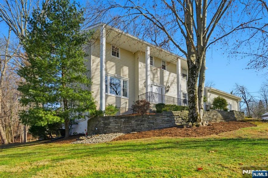 Pride of ownership shines throughout this move-in ready, beautifully updated 4-bedroom, 3-bath Colonial ideally located in Wayne, just minutes from mass transit and everyday conveniences. An inviting front porch with classic pillars welcomes you into a meticulously maintained interior featuring hardwood floors, recessed lighting, skylights, and a cozy wood-burning fireplace in the family room. The updated kitchen showcases quality finishes and a Sub-Zero refrigerator, with sliders on both levels opening to a spacious deck for seamless indoor-outdoor living. A standout feature is the fully finished walk-out basementâ€”an impressive, flexible space offering private outdoor access, a den, game/poker area, and generous storage, ideal for guest accommodations, recreation, or additional living space. A two-car garage and prime location complete this exceptional home.