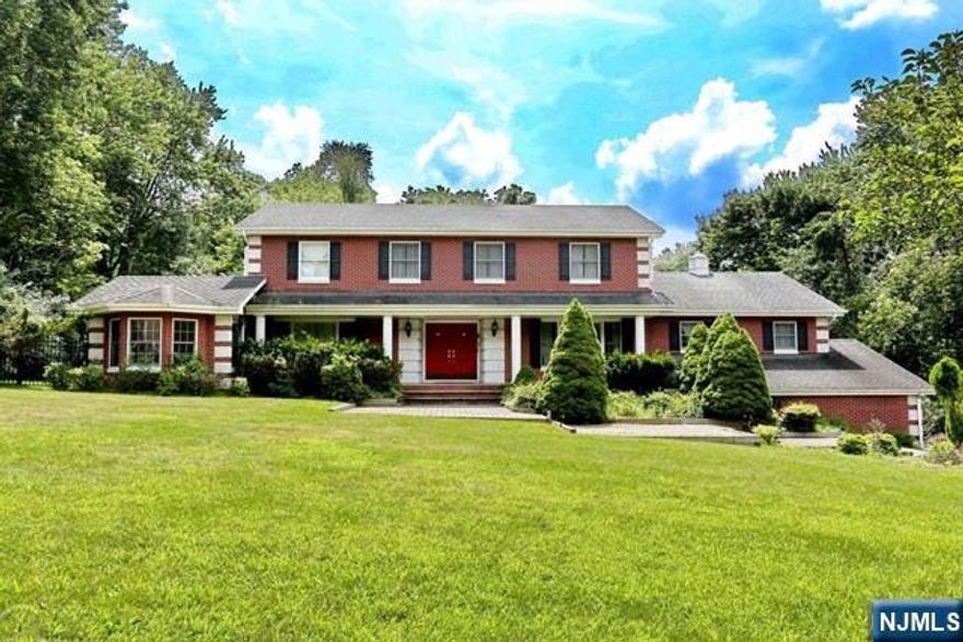 Welcome to an exceptional family home that effortlessly combines luxury and everyday comfort. Nestled on a serene street containing a double cul de sac , this stunning 4475 sq. ft. residence sits on a level builder's acre and offers ample space and privacy. With 5 bedrooms, 3 full baths, and 4 car garages, it's designed to cater to both grand entertaining and practical family living. Step inside to discover a bright and inviting dream kitchen flooded with natural light. High end appliances custom cabinetry & elegant granite countertop-including a striking 12 ft. island-create an inviting space for culinary adventures & social gatherings. The kitchen connects to sprawling 1100+ sq.ft. deck, a sophisticated wood-paneled den with cozy wood burning fireplace, and an oversized dining room adorned with two dazzling chandeliers. The main level features a private guest bedroom with access via a separate back stairwell along with a full bath, and laundry area. A formal living room with a gas fireplace with windows front, back and side connects to an elegant media/library which provides the perfect setting for both relaxation and entertainment. Downstairs the fully finished basement offers even more possibilities. A professionally designed wine cellar with space for 100s of bottles sets the stage for intimate tastings and memorable evenings. With plumbing in place for an additional bedroom, or bath customizes options abound.