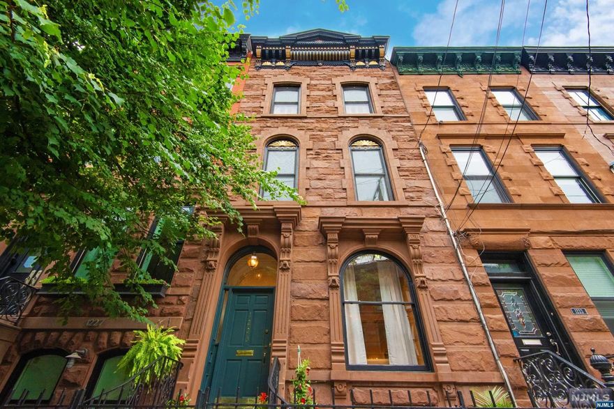 Sophisticated, modern elegance, meets turn-of-the century craftsmanship in this large four-story brownstone located on one of Hoboken's most coveted desirable uptown blocks. Welcome to 1225 with incredible living space over four levels, on an 18x100 lot with 4 BR, (easily converted to 5), and 3.5 BA. Constructed in 1892 the home exhibits remarkable period details,both restored and preserved. Solid brownstone front, two working fireplaces, antique pocket doors, parquet flooring, soaring 11-foot ceilings with historic moldings and detail. Large windows on three sides stream in light. A legal 2 family, easily converted to a one, with bonus brand new 1 BR apartment. Incredible Primary Suite with walk-in closet antique glass, and luxury bath. Large Casual Second floor living with wine fridge and 2 or 3 BR. Amazing first floor details, dining for large dinner parties, and new designed yard. Best block in Hoboken, easy access to Ferry, Bus, Shops, dining. Perfection!