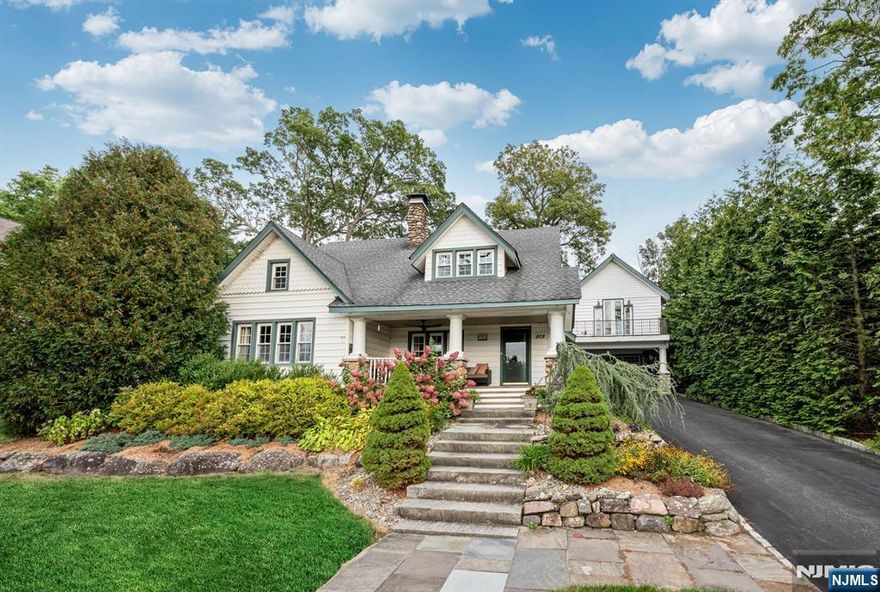 Picturesque, Perfect, & Truly Special! This storybook 4-bedroom home is filled with character, charm, & stunning craftsmanship inside & out. Set gracefully up from the road, its glorious stone exterior & peaceful lake views welcome you from the start. Follow the stone walkway to the inviting front porch & step inside to discover a sun-drenched living room with a striking stone fireplace. A bright breakfast room with built-ins opens to the beautifully updated kitchen, rich in detail & style, leading out to a covered patio with an outdoor fireplace, Koi pond & lovely landscaping-an entertainer's dream! The main floor continues with a formal dining room featuring a charming window seat & built-in cabinetry, a private study, spacious family room & 2 full baths. Upstairs you'll find 4 bedrooms and another full bath, while the basement offers laundry & storage. A detached 2 car garage adds even more versatility with a private studio/office/workshop above, complete with a balcony & separate entrance. Rich in detail & thoughtful updates, this home boasts wood floors, recessed lighting, newer windows, updated baths & architectural nooks throughout. This property includes a private dock with gazebo. As an active member of the Awosting Association, residents enjoy access to tennis courts, beach, clubhouse, boathouse & park-a true "staycationâ€ lifestyle. This one-of-a-kind property is brimming with warmth, beauty, & timeless appeal-a perfect blend of elegance, comfort & lakeside living