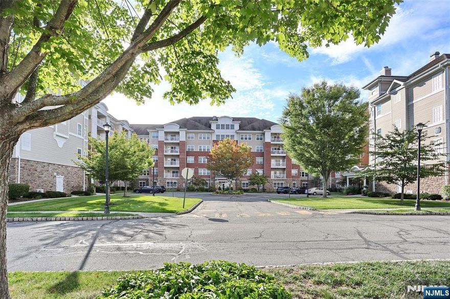 Wonderful 1910 SF 4th floor Ryerson model in Wanaque Reserve, a Del Webb active adult 55+ community. Just painted, this move-in ready home features hardwood floors, an extra large 18x19 SF primary BR ensuite with FB, tray ceiling & WIC, 2nd BR FB, EIK with granite counters, SS appliances, & tiled backsplash, LR, DR & den/home office with French doors, adding a touch of elegance. The LR sliding doors open to a private, tiled balcony, with a beautiful, serene mountain view. Amenities include a deeded, underground parking spot, & 24-hour security. The 20,000 SF clubhouse has a cafe, ballroom, gym, theater, sauna, indoor & outdoor pools & more than 45 clubs & activities, which include the travel club (cruises, day trips, casino trips), tennis, pickleball, canasta, poker, golf, etc. Conveniently located next to the clubhouse. WR offers a luxurious lifestyle for its residents with a focus on modern amenities, security and a sense of community. The recent renovation adds a fresh and updated living environment.