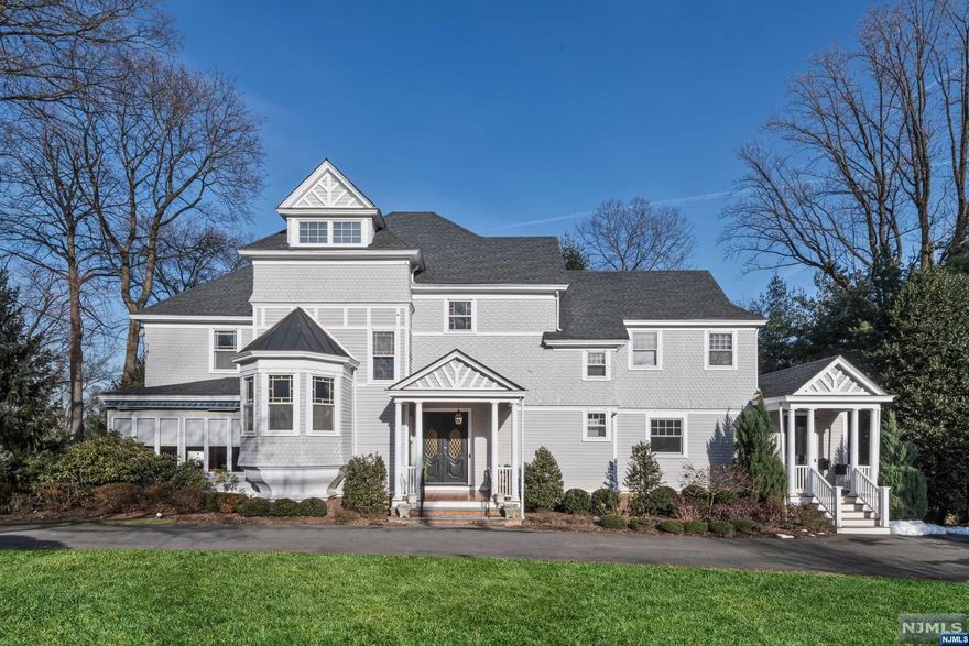 This iconic 1875 Victorian Colonial manor is a true piece of Ridgewood history and has been masterfully updated for today's modern lifestyle. Located in the heart of the Village just steps to downtown shops, restaurants, and commuter transportation. Brimming with architectural details, features include a grand entry foyer with spectacular woodwork, handmade mahogany doors, 10-foot ceilings, and five unique tile inlay fireplaces. The centerpiece of the home is the newly renovated and expanded gourmet kitchen, with a large seated island, professional grade appliances, and custom bar area. A gorgeous primary suite features a private balcony, large sitting room, two fireplaces, remodeled bath, and large walk-in closet. 10 foot wide glass doors off the kitchen open to a handsome raised deck that runs the length of the home overlooking more than half acre of private property, offering year-round entertainment options. Don't miss this landmark home! Owner holds NJ real estate license.